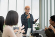 © PhugunStock - Asian male businessman explaining Happily holding a tablet in a meeting, brainstorming and talking about analysis, innovation, collaboration. online business Sales techniques and strategic planning