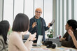 © PhugunStock - Asian male businessman explaining Happily holding a tablet in a meeting, brainstorming and talking about analysis, innovation, collaboration. online business Sales techniques and strategic planning