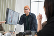 © PhugunStock - Asian male businessman standing explaining meeting, smiling happily and brainstorming, discussing analysis, innovation, collaboration. online business Modern sales techniques and strategic planning