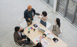 © PhugunStock - Top view of business people, Asian man and woman looking at camera, hands raised, happy, talking about analysis, innovation and collaboration. Online business, sales techniques, strategic planning