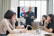 © PhugunStock - Businessman, Asian man and woman holding a tablet The meeting was tense. Brainstorm and talk about analysis, innovation, and collaboration. online business Modern sales techniques strategic planning