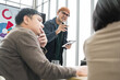 © PhugunStock - Businessman, Asian man and woman holding a tablet The meeting was tense. Brainstorm and talk about analysis, innovation, and collaboration. online business Modern sales techniques strategic planning