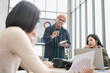 © PhugunStock - Businessman, Asian man and woman holding a tablet The meeting was tense. Brainstorm and talk about analysis, innovation, and collaboration. online business Modern sales techniques strategic planning