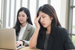 © PhugunStock - Asian businesswomen sit in a tense meeting and brainstorm, discussing analysis, innovation, collaboration. online business Modern sales techniques and strategic planning