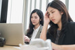 © PhugunStock - Asian businesswomen sit in a tense meeting and brainstorm, discussing analysis, innovation, collaboration. online business Modern sales techniques and strategic planning