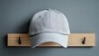 © Andre Jovi - Grey Baseball Cap Hanging On Wooden Rack