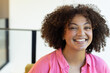 © Wavebreak Media - Smiling woman in pink shirt, promoting body positivity and confidence, at home, at home