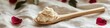 © Alla - A wooden spoon filled with cream sitting on a bed, perfect for breakfast or dessert