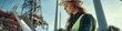 © Alena - Woman in a hard hat using scissors on site
