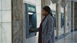 © Arifin Studio - Woman using ATM in modern lobby. Possible use Stock photo for financial services