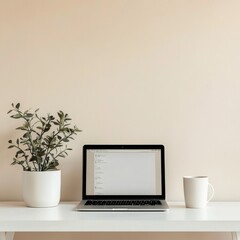 Poster - Minimalist Workspace Setup: Laptop, Plant, and Coffee Mug on White Desk Against a Neutral Background