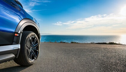Wall Mural - new suv blue color with black details and white the car is parked on an open road overlooking sea