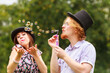 © Voyagerix - Couple blowing soap bubbles, having fun