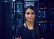 © Tetra Images - Portrait of smiling female technician in server room 