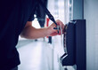 © Tetra Images - Close-up of employee using keycard and digital door lock in server room