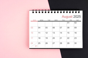 Wall Mural - August 2025 desk calendar on pink and black background, Flat lay.