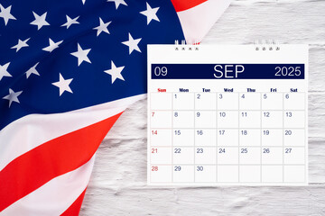 Wall Mural - September 2025 Monthly desk calendar and United States of America flag.