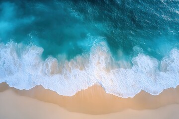 Poster - Aerial view of turquoise ocean wave crashing on sandy beach creating white foam pattern