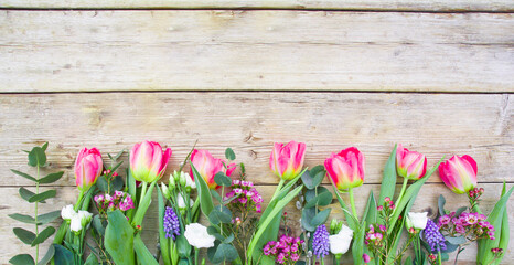Wall Mural - spring flowers on wooden background - Happy Easter greeting card - season banner with copy space
