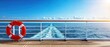 © Gibster - Vibrant ocean view from a cruise ship with a lifebuoy in the foreground.