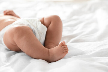 Wall Mural - Cute little baby in diaper on bed, closeup