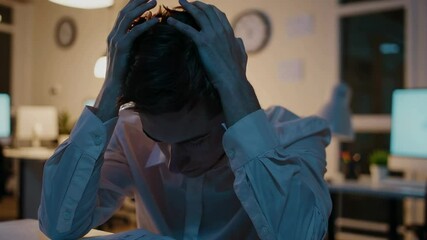 Poster - Professional businessman gripping head, revealing intense workplace stress and emotional exhaustion during late night work moment in dramatic slow motion sequence