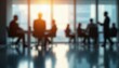 © miss irine - Blurred silhouettes of business people in modern office with sunlight through large windows. Business team meeting, conference, collaboration in workspace. Corporate interior, dynamic space,