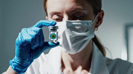 Poster - Medical professional wearing protective blue nitrile gloves and surgical mask carefully examining vaccine vial against clinical background with professional precision