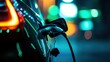 © Alex - A close-up view of an electric car charging at night, showcasing vibrant neon lights in the background. The modern design highlights the shift towards sustainable energy solutions.