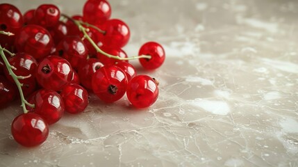 Poster - A cluster of vibrant red currants on a smooth marble surface.