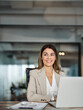 © insta_photos - Happy mid aged professional business woman working in office with laptop looking away at copy space. Smiling mature businesswoman executive or lawyer at workplace thinking of new ideas plan.