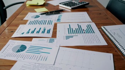 Fototapete - Professional business documents with financial charts and analytical diagrams flowing across wooden surface during slow motion sequence revealing strategic workplace insights