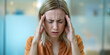 © Inspire Shots Hub - A woman with blonde hair experiencing a headache while holding her head in pain in a modern office. The image conveys stress, exhaustion, and the mental strain of work or daily life.