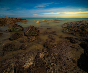 Wall Mural - Aerial panorama of Thailand's verdant with blue and aquamarine the sea, and clouds shining by sunlight in the background. Chonburi, Thailand.