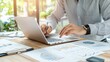 © Nattapol - Focused entrepreneur working on laptop in modern office