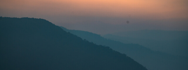 Wall Mural - experience peaceful beauty of mountain landscape: scenic view of sunset and sunrise at the peak, sil