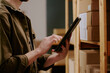 © AnnaStills - Young man checking inventory on shelves using tablet in warehouse setting highlighting efficiency and modern technology implementation for stock management