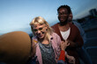 © liderina - Group of Multi-Ethnicity people having fun outdoor in the night. Celebrate.