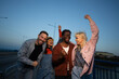 © liderina - Group of Multi-Ethnicity people having fun outdoor in the night. Celebrate.