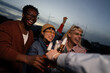 © liderina - Group of Multi-Ethnicity people having fun outdoor in the night. Celebrate.