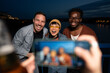 © liderina - Group of Multi-Ethnicity people having fun outdoor in the night. Celebrate.