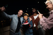 © liderina - Group of Multi-Ethnicity people having fun outdoor in the night. Celebrate.