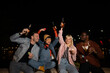 © liderina - Group of Multi-Ethnicity people having fun outdoor in the night. Celebrate.