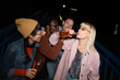 © liderina - Group of Multi-Ethnicity people having fun outdoor in the night. Celebrate.