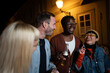 © liderina - Group of Multi-Ethnicity people having fun outdoor in the night. Celebrate.
