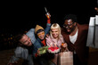 © liderina - Group of Multi-Ethnicity people having fun outdoor in the night. Celebrate.