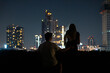 © Allison - Couple enjoys a breathtaking view of Bangkok's skyline from a rooftop at night