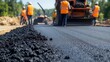 © felix_brönnimann - Road construction workers laying asphalt on a highway with heavy machinery in the background for infrastructure development and maintenance.