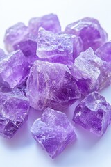 Poster - Captivating pile of raw amethyst crystals with vibrant purple hues on a clean white background in a studio shot
