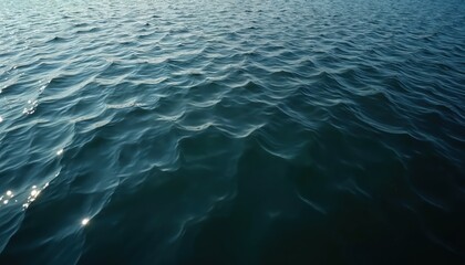 Leinwandbilder - Overhead view of rippled sea water surface. Blue ocean water, dark in distance, reflects sunlight in form of many sun glitters. Liquid texture pattern background. Calm, peaceful mood, abstract nature.
